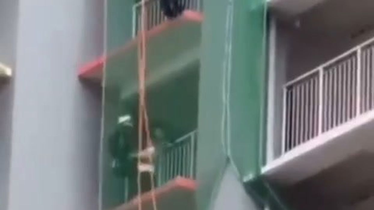 Donna tenta il suicidio dal balcone e i pompieri la salvano così | video