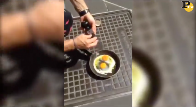Caldo record: cuoco cuoce uovo al tegamino su un tombino
